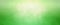 Green background with soft bokeh blur and bright yellow sun spot in elegant fresh and clean banner