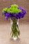 Green Ball Dianthus Barbatus Sweet William and Dark Purple Statice Limonium sinuatum Flowers  on natural burlap. Purple