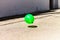 Green balloon floating in the street, concept of solitude and isolation