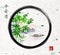 Green bamboo trees, island with mountains and fishing boat in black enso zen circle. Traditional oriental ink painting