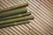 green bamboo trunks on wooden litter background