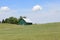 Green barn on hill