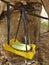 A green bath soap hanging with blue thread in a yellow basket in a jungle