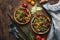 Green beans with roots, vegetables, mushrooms, spices and tomatoes, vegan bowls. Food cooking background, vintage wooden rustic