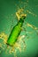 Green beer bottle with splashing liquid