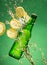 Green beer bottle with splashing liquid