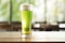 Green beer glass on blurred background with copy space for stPatrick s day text placement