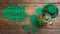 Green beer, hat and clover leaves on table, flat lay. St. Patrick`s Day celebration