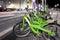 Green Bikes Parked - City Street at Night