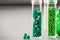 Green biodegradable plastic granules in test tubes