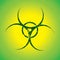 Green biohazard sign over yellow background