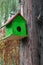 Green birdhouse in nature