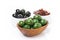 green and black olives, sun-dried tomatoes in a bowls, isolated