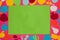 green blank paper around which is a pink background with colorful fruit, healthy background