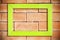 Green blank wood frame on brick wall