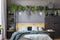 Green blanket and grey pillows on wooden bed in floral bedroom i