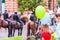 Green blue balloons on foreground and armed mounted police forces riding at the end of Pride parade on Gedimino street on the