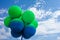 Green and blue balls balloons on cloud sky background. Vivid holiday poster with copy space. Sunny happy day concept