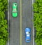 Green and blue cars on the road, the view from the top