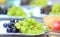 Green and blue grapes on a plate