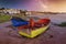 A green and blue wooden fishing boats under a milky way on the Paternoster beach