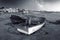 A green and blue wooden fishing boats under a milky way on the Paternoster beach in black and white.