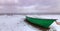 Green boat on beach