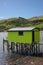 Green boat house on stilts