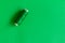 Green bobbin of thread isolated on green background, monochrome picture of sewing things