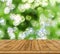 Green bokeh abstract light background, a lot forest bokeh with wood table