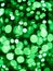 Green bokeh background. Irish luck color theme. Random round shape