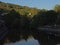 Green borders of river Ourthe near La-Roche-en-Ardenne in the evening