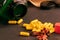 Green bottle of supplements with yellow capsules on a black background