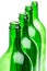 Green bottles standing in a row on white background