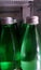Green bottles of water same size in the refrigerator