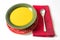 Green bowl on a decorative plate filled with orange butternut or carrot soup, vivid red napkin and spoon