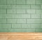 Green brick background and wooden floor