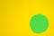 A green bright circle on a yellow background. Space copy. The embodiment of ideas.