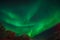 Green bright dancing Northern lights in Leknes, Lofoten Islands Norway