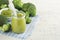 Green broccoli baby food in white bowl and jar on table. Green baby food. Child first feeding concept. Baby Natural Food.