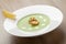 Green broccoli cream soup puree with filleted salmon and lemon