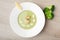 Green broccoli cream soup puree with filleted salmon and lemon