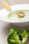 Green broccoli cream soup puree with filleted salmon and lemon