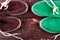 Green and brown suede espadrille shoes on wooden background.