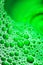 Green bubbles. Selective focus aesthetic liquid pattern background image.