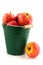 Green bucket with red apples