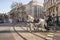 Green buggy with white horses driving through