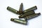 Green bullets and casings from Kalashnikov automatic rifle at white background