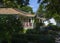 Green bungalow on a leafy street