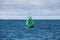 Green buoy with cone shaped topmark